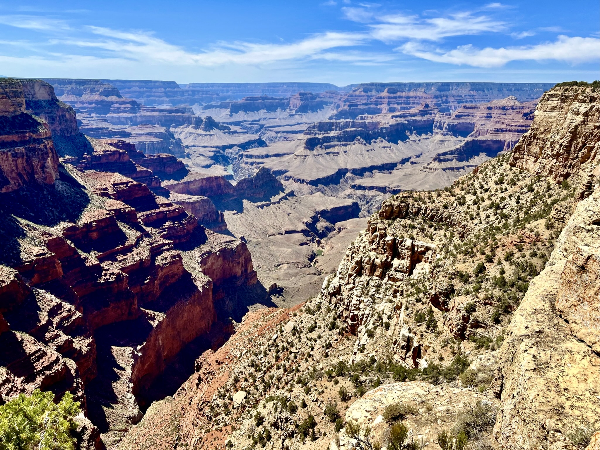 Grand canyon view with red, orange, beige and gray canyon walls.