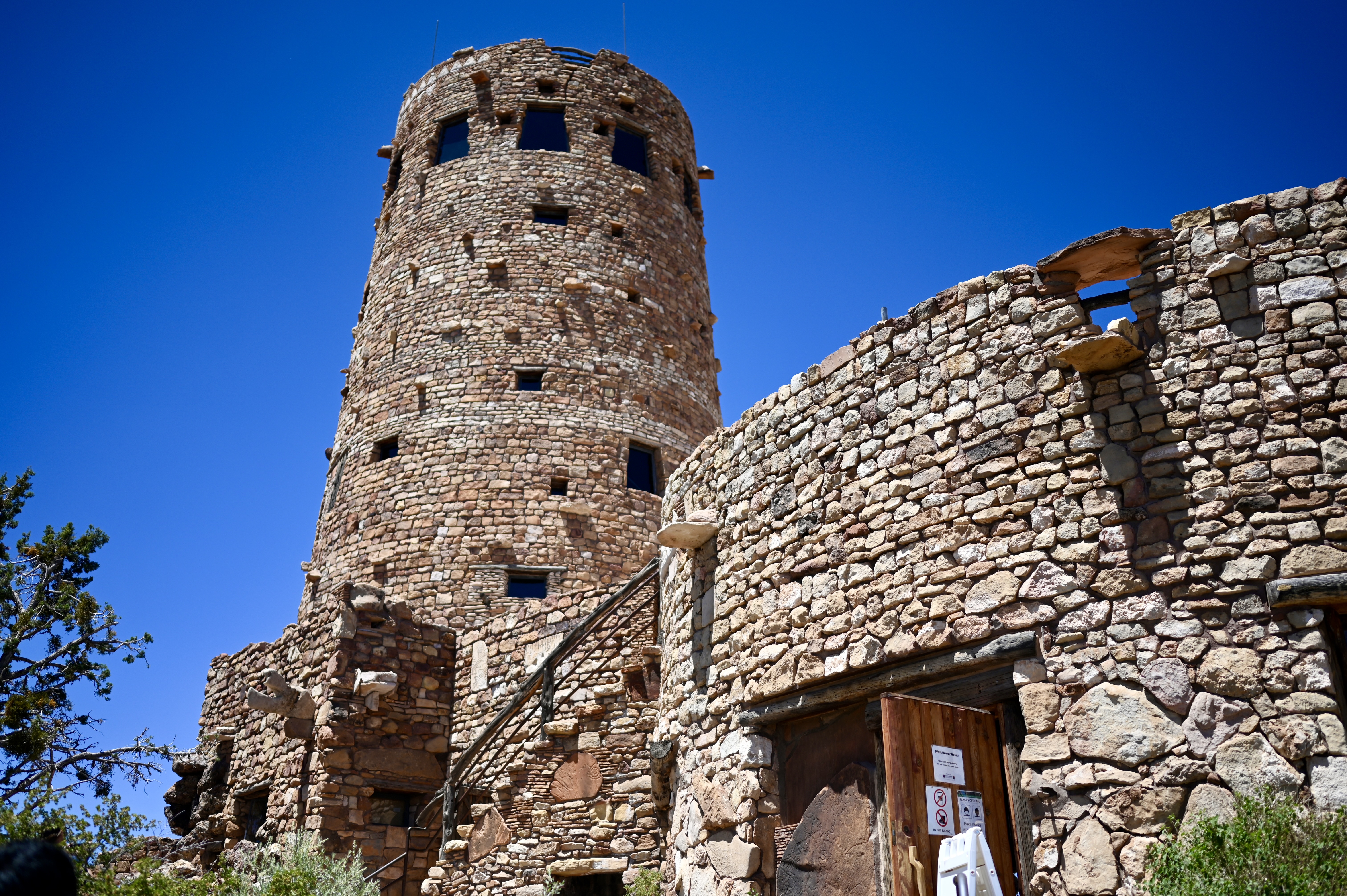 Round building and watchtower made of sandstone or limestone with stairs with railing to go to the upper level.