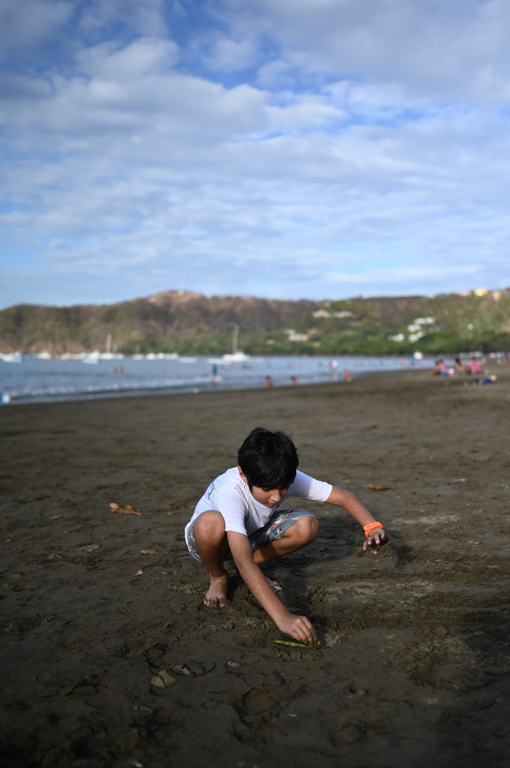 Playing on black sand at Coco beach