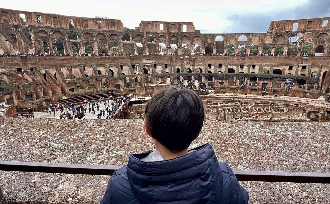 Boy looking out over the inside of the Colosseum