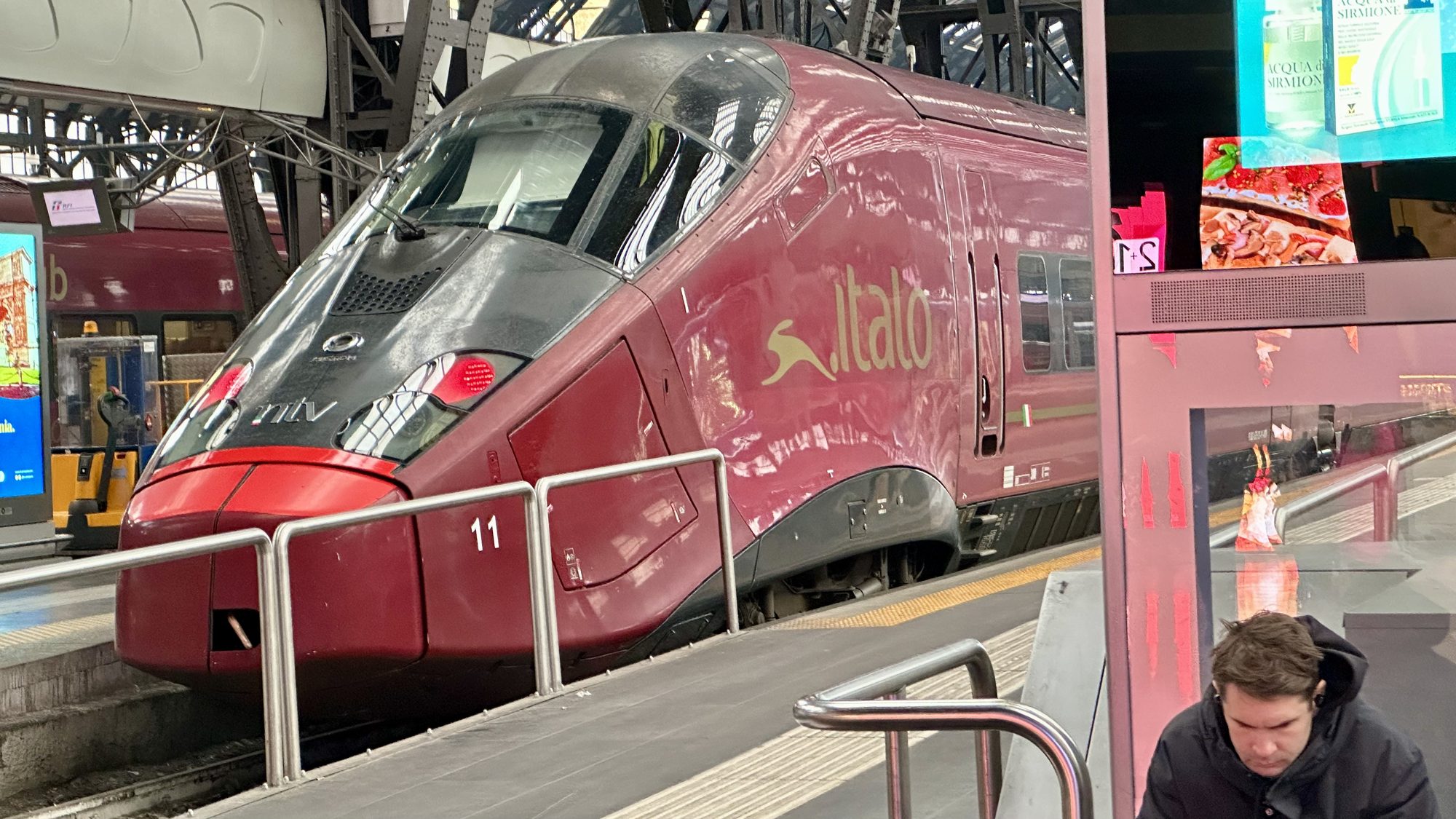 A red Italo high-speed train at the platform in Milano Centrale