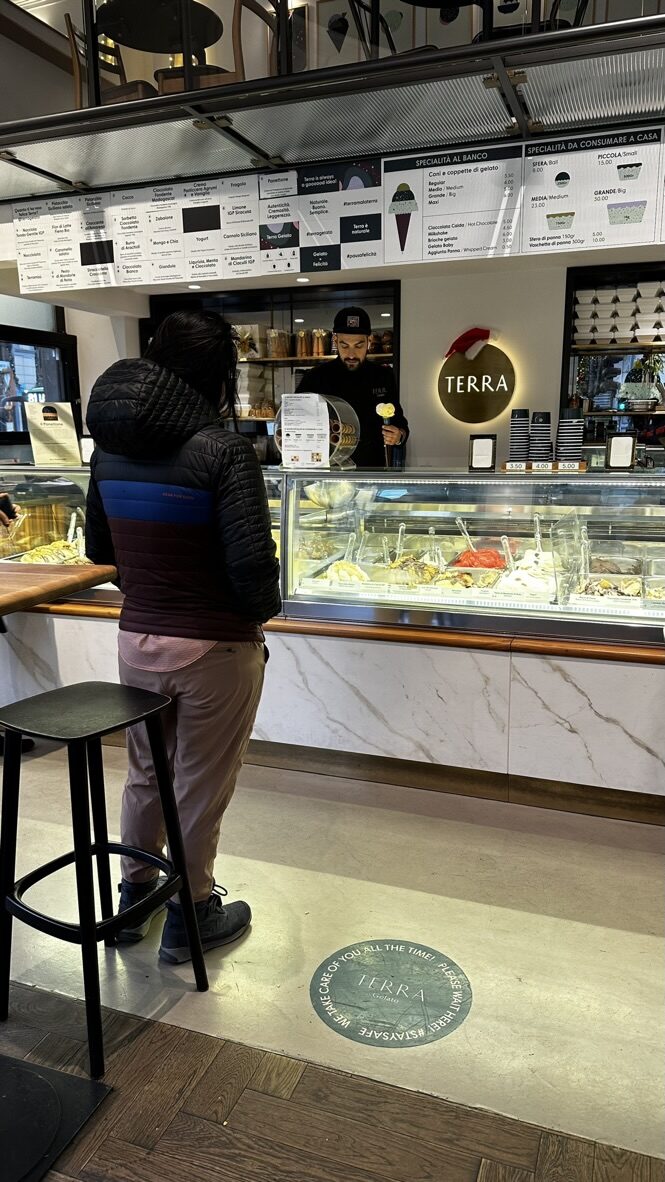 Ordering at the counter of a modern gelato shop