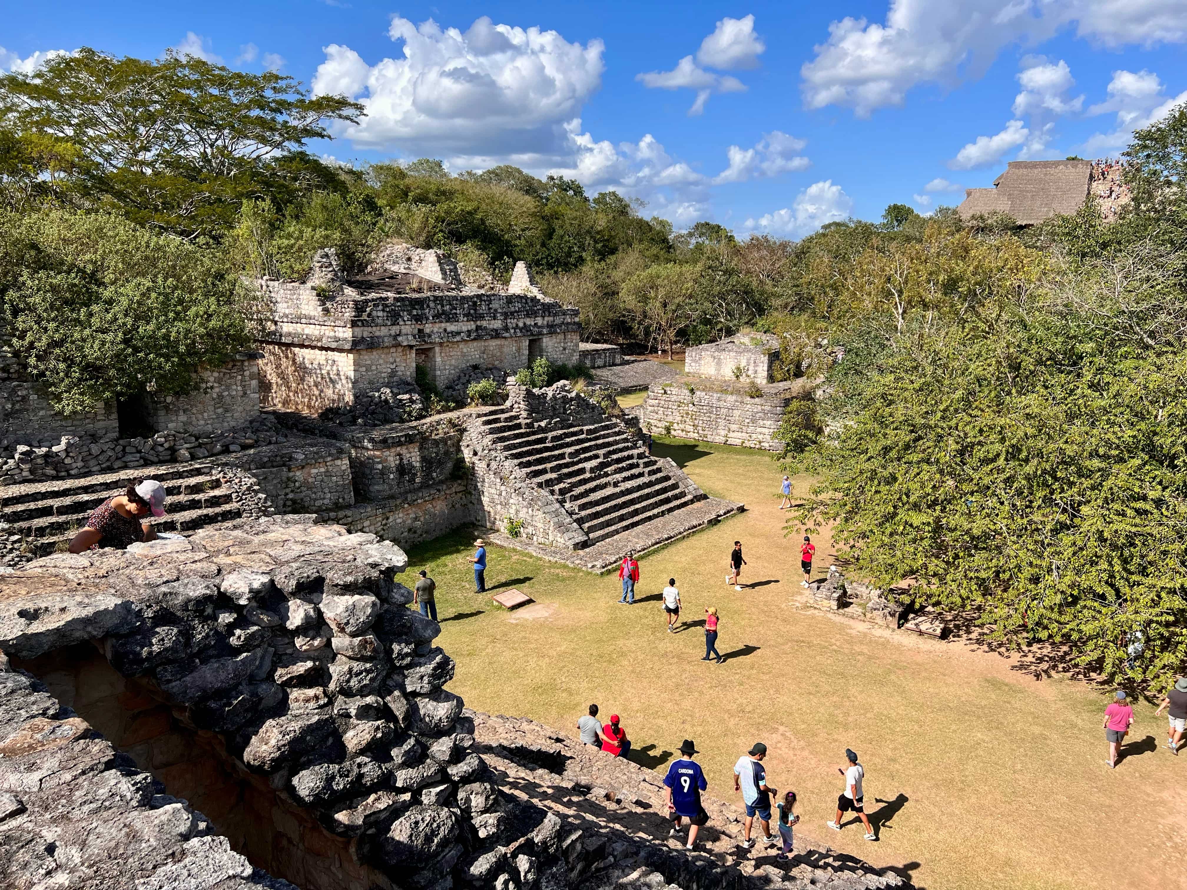 Mayan ruins in Ek Balam showing the grassy grounds with visits all around