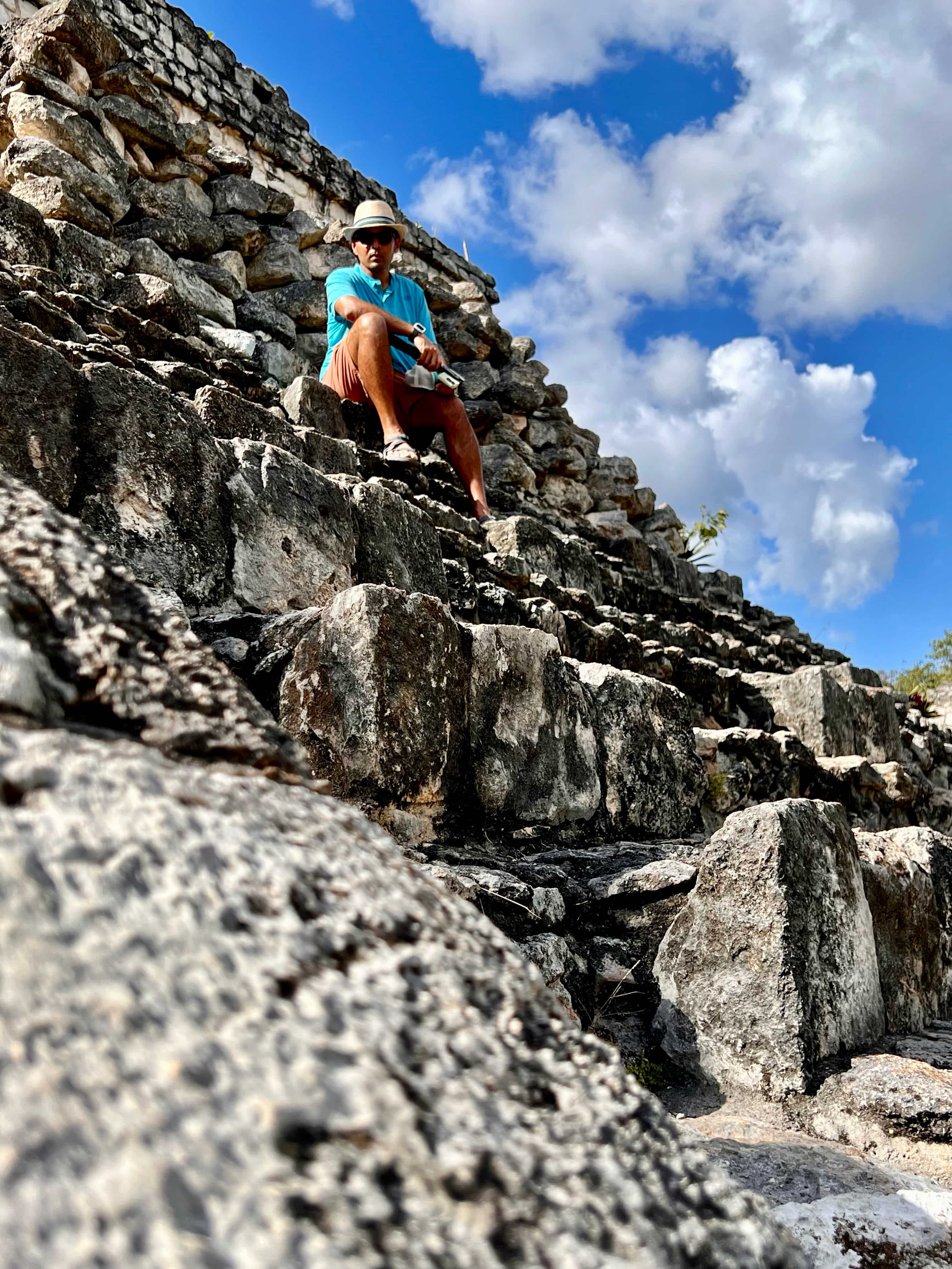 Man sitting on Mayan pyramid in Ek Balam, Mexico