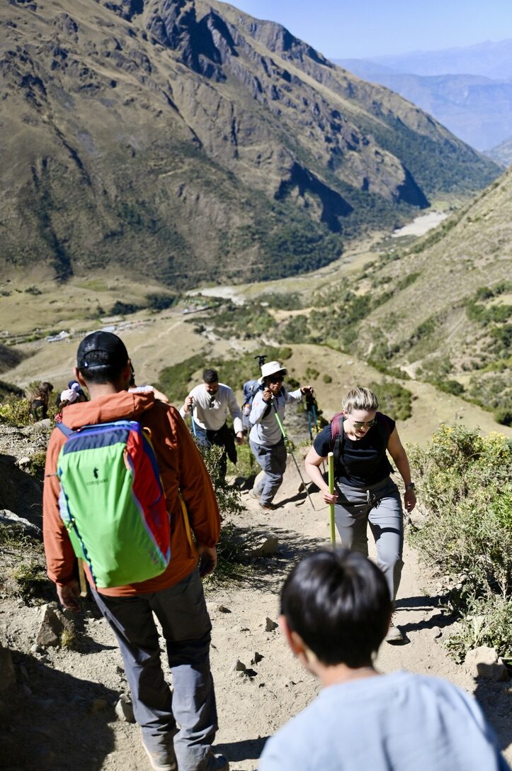 Hikers making their way down the dusty, rocky trail