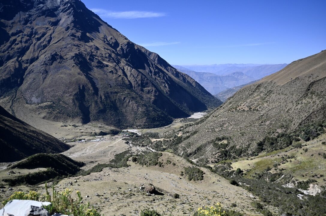 A wide valley stretching away below the trail, seen from horseback