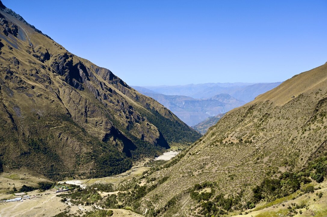 A deep green valley between steep mountainsides