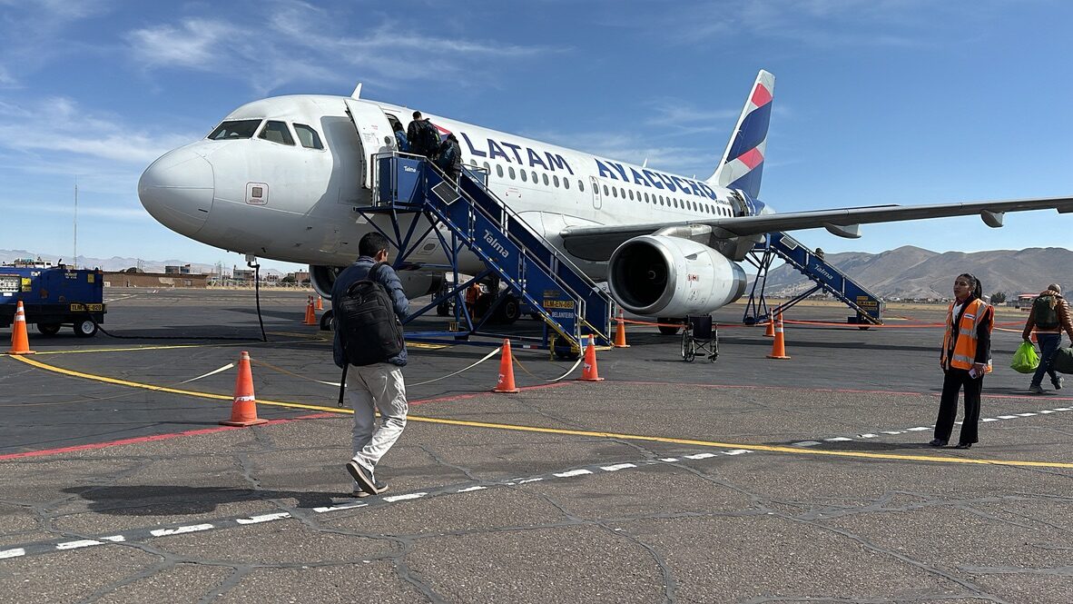 Passengers boarding a LATAM plane from the tarmac by stairs