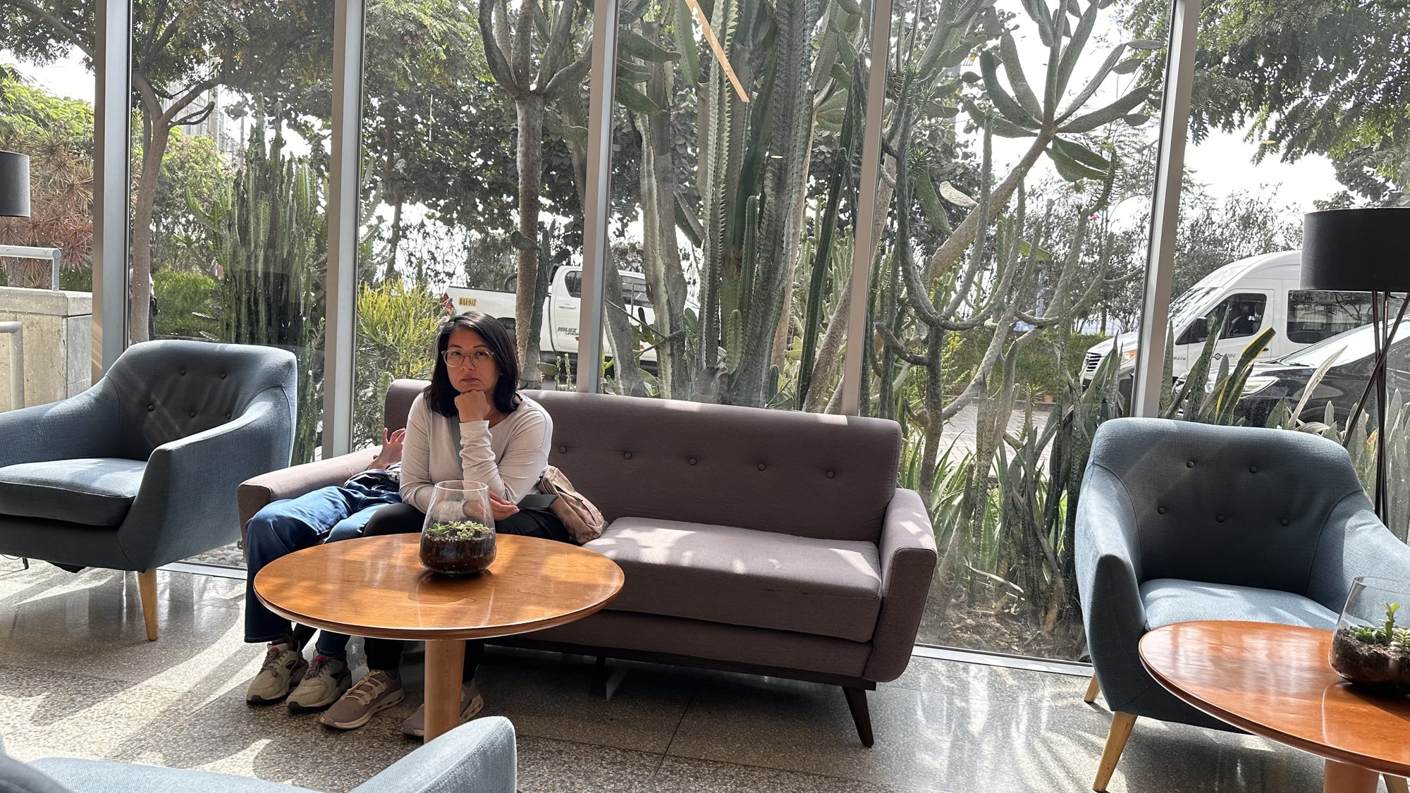 Woman sitting on a sofa in the hotel lobby, waiting