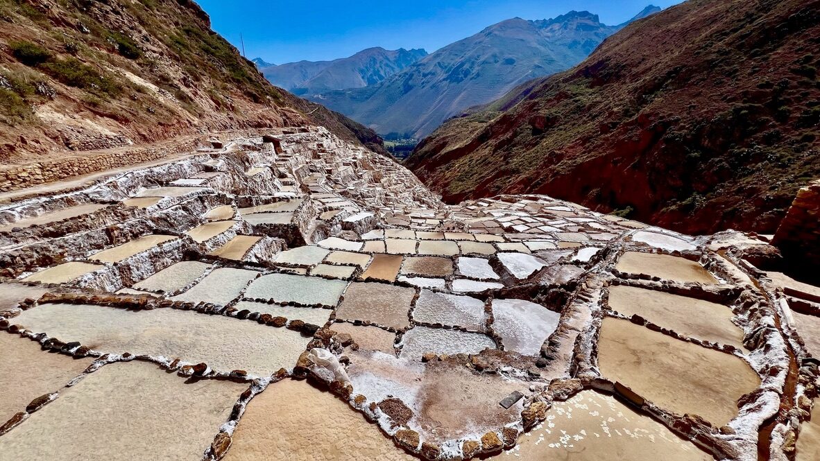 Close-up of the salt pans of Maras, with mountains beyond