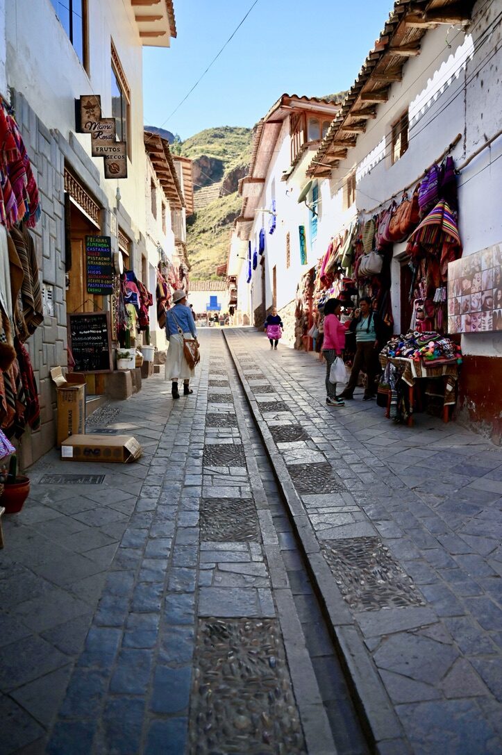 A narrow cobbled street in Pisac lined with shops