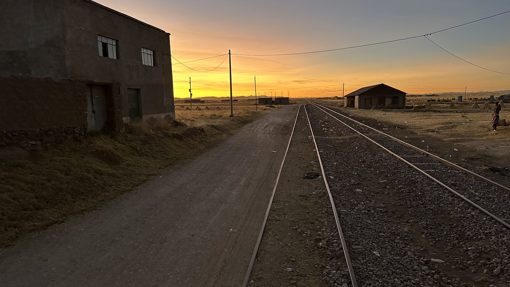 The tracks at sunset, with low buildings on either side