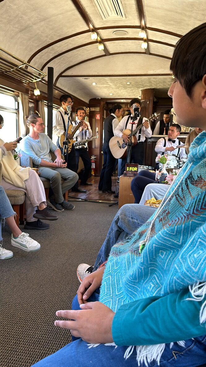 Musicians performing in the aisle of the train carriage