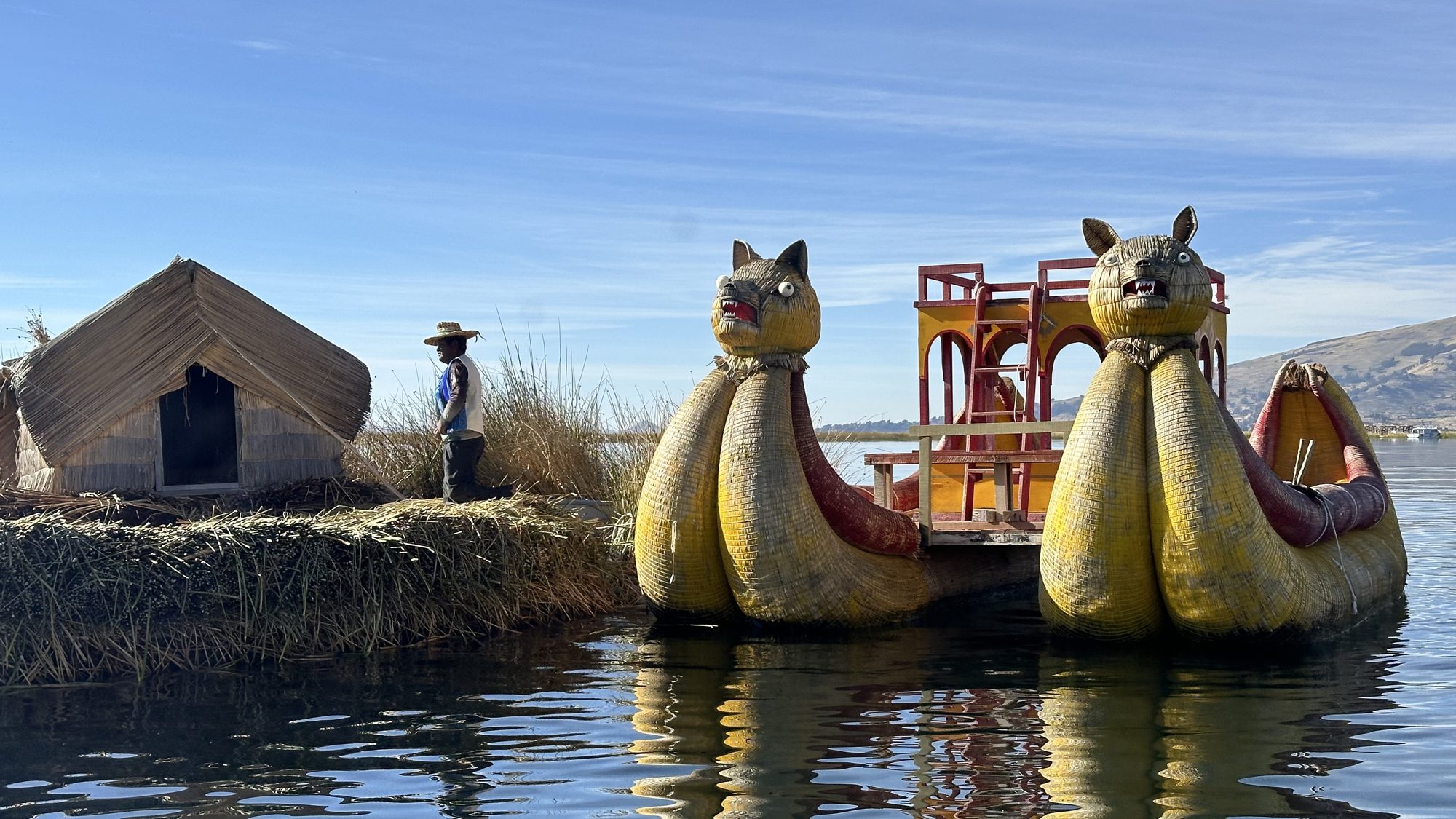 Two large reed boats with puma-head prows moored beside a reed island