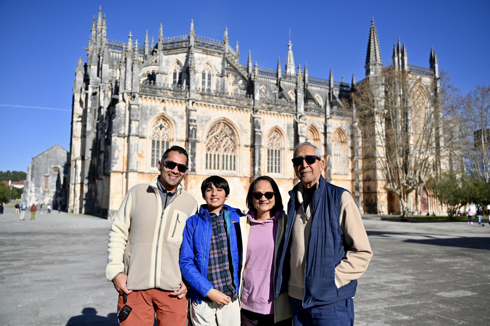 Four of us standing in the square in front of the Gothic Batalha Monastery.