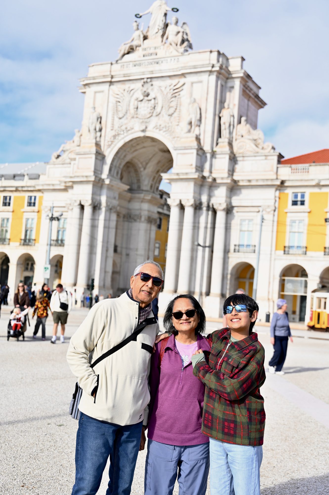 Three of us in the Praça do Comércio, in front of the white triumphal arch and the square’s yellow arcades.